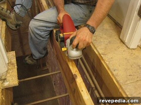 DIY Hardwood Floor Installation Guide: Step-by-Step for Lasting Results 3 PlaningAJoist_HardwoodInstallation_080410.jpg