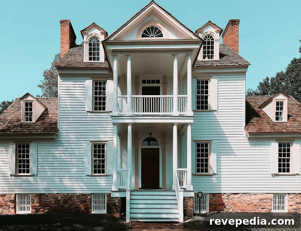 Large modern white house with a brown roof