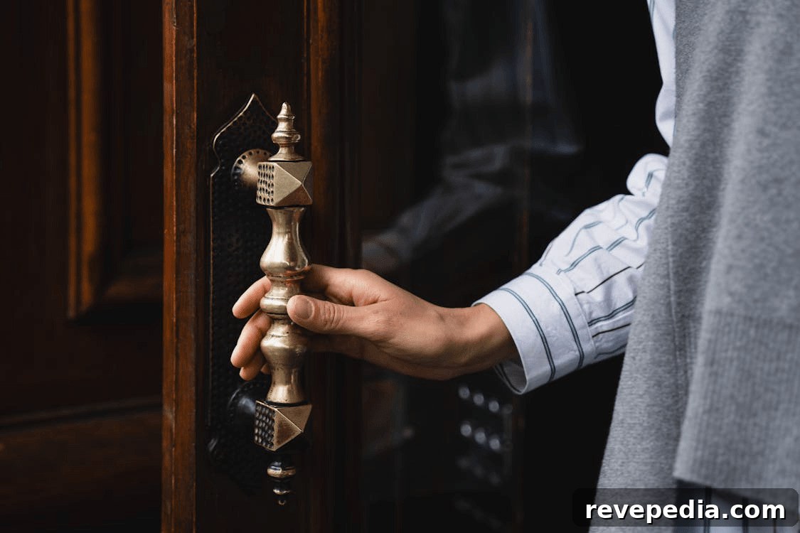 Top Home Security Upgrades to Protect Your Property 2 Hand opening a home door, illustrating