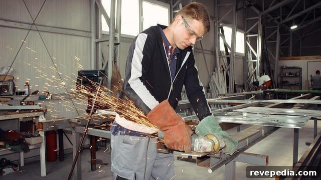 Organize Your Power Tools: Smart Storage Ideas for Home Workshops 2 Man operating a grinder power tool to shape metal