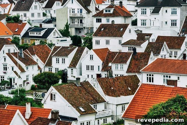 Group of white houses with red roofs, representing