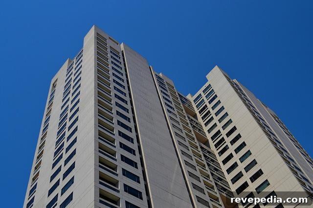Top Property Management Companies to Consider for Your 2026 Rental Setup 3 Modern tall building with large windows, representing a