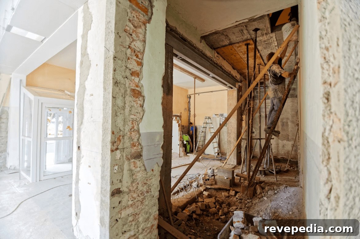Home Renovation Budgeting: Plan, Save, and Finance Your Upgrades 3 Man surveying a room under construction for renovation