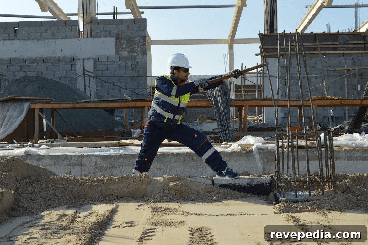 Construction worker with hard hat and overalls holding
