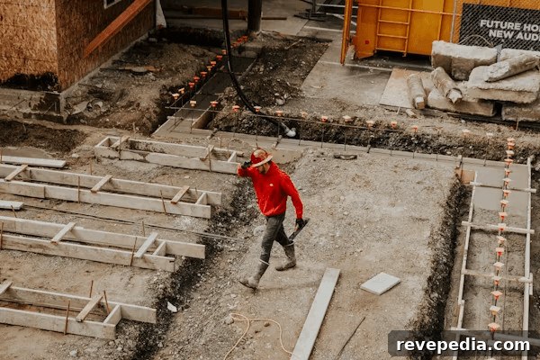Man in red jacket on a construction site,