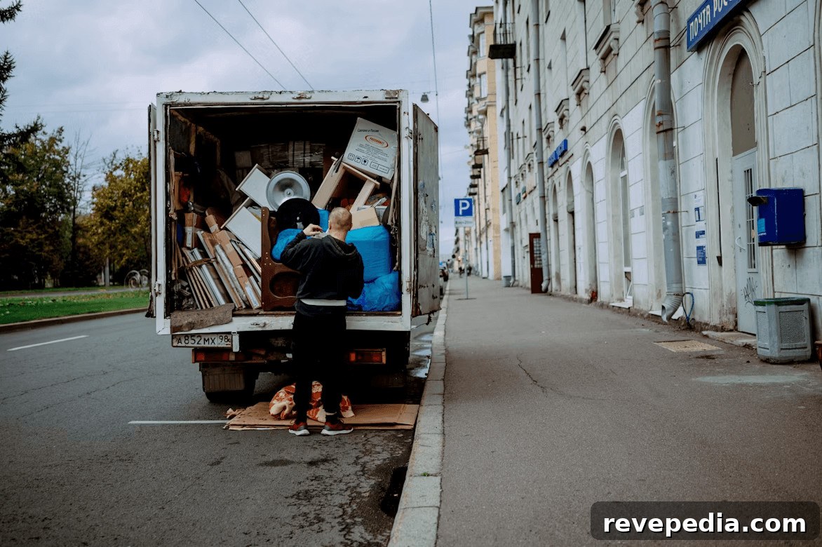 Moving to McLean? Essential Tasks to Complete Before Moving Day 3 Man unloading furniture from a moving truck in McLean