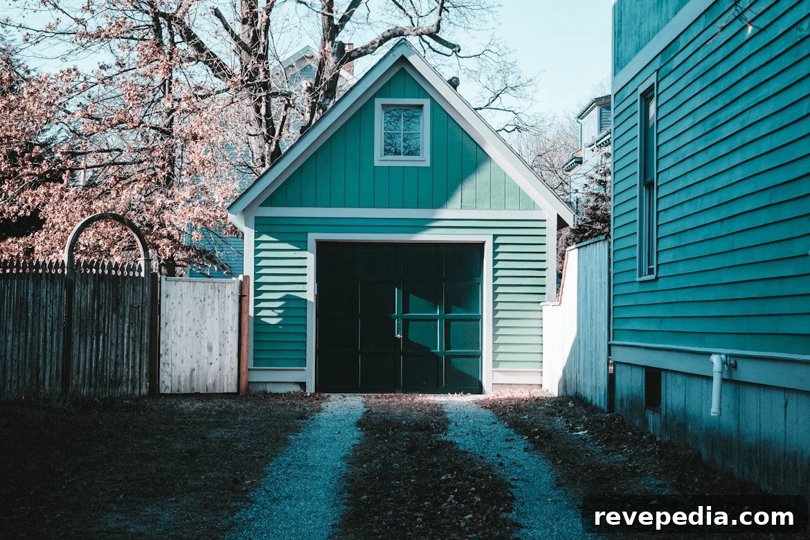 Small green building with a black garage