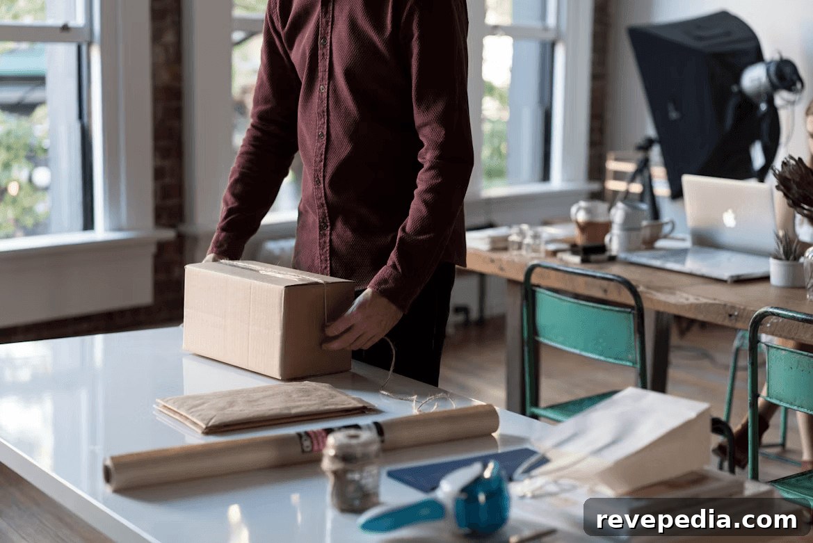 Man packing a box on a table before moving