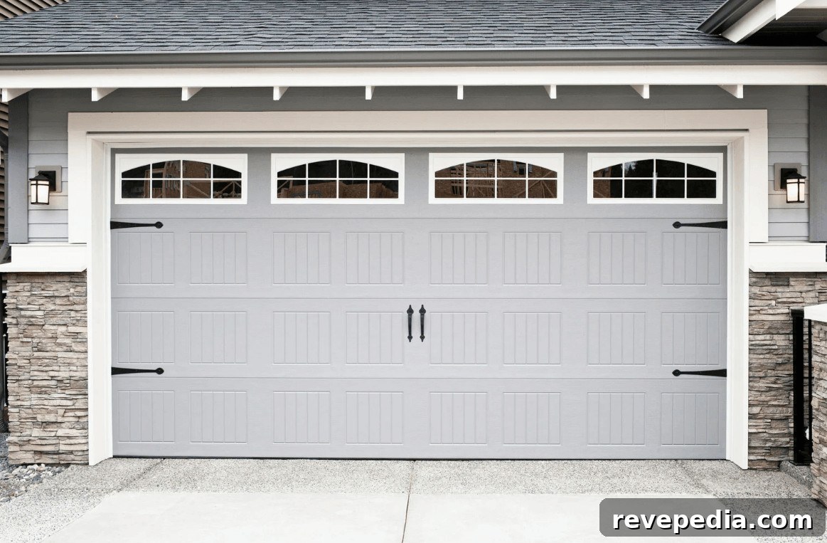 Gray garage door with windows on a house