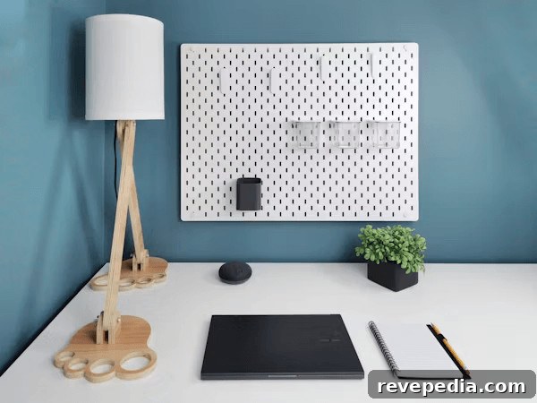 DIY Pegboard Ideas to Organize Classroom and Study Materials 2 White desk with a laptop, lamp, and space