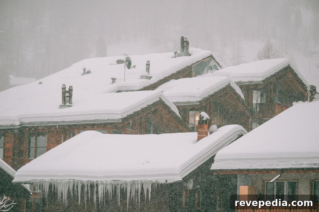 When Your DIY Repairs Exceed Your Skills and Budget 2 A snow-covered house with long icicles hanging from the roof edge in winter