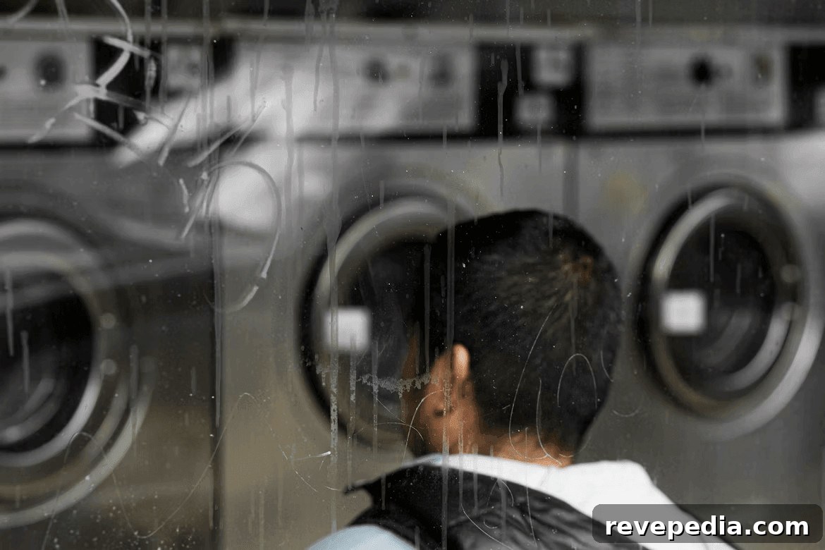 Man examining washing machines Man examining a row of washing machines
