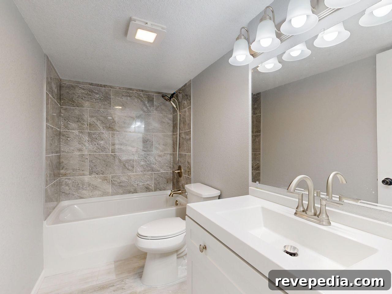 modern bathroom with sink, toilet, and bathtub