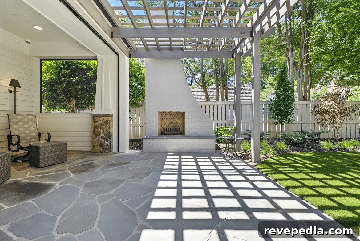 Patio with fireplace and seating area under a