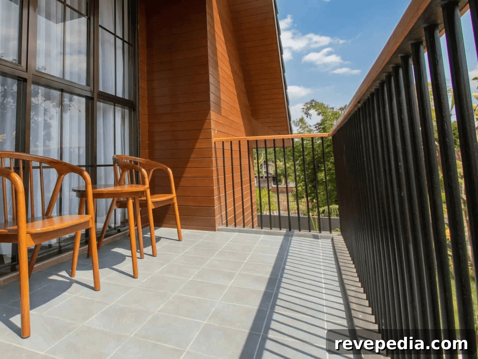 Two wooden chairs on a balcony overlooking a building