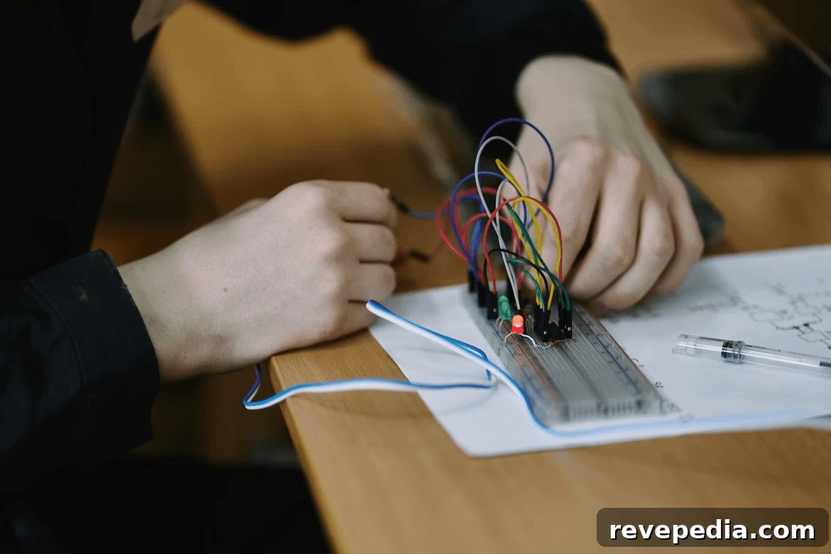 Person working on an electronics project with wires