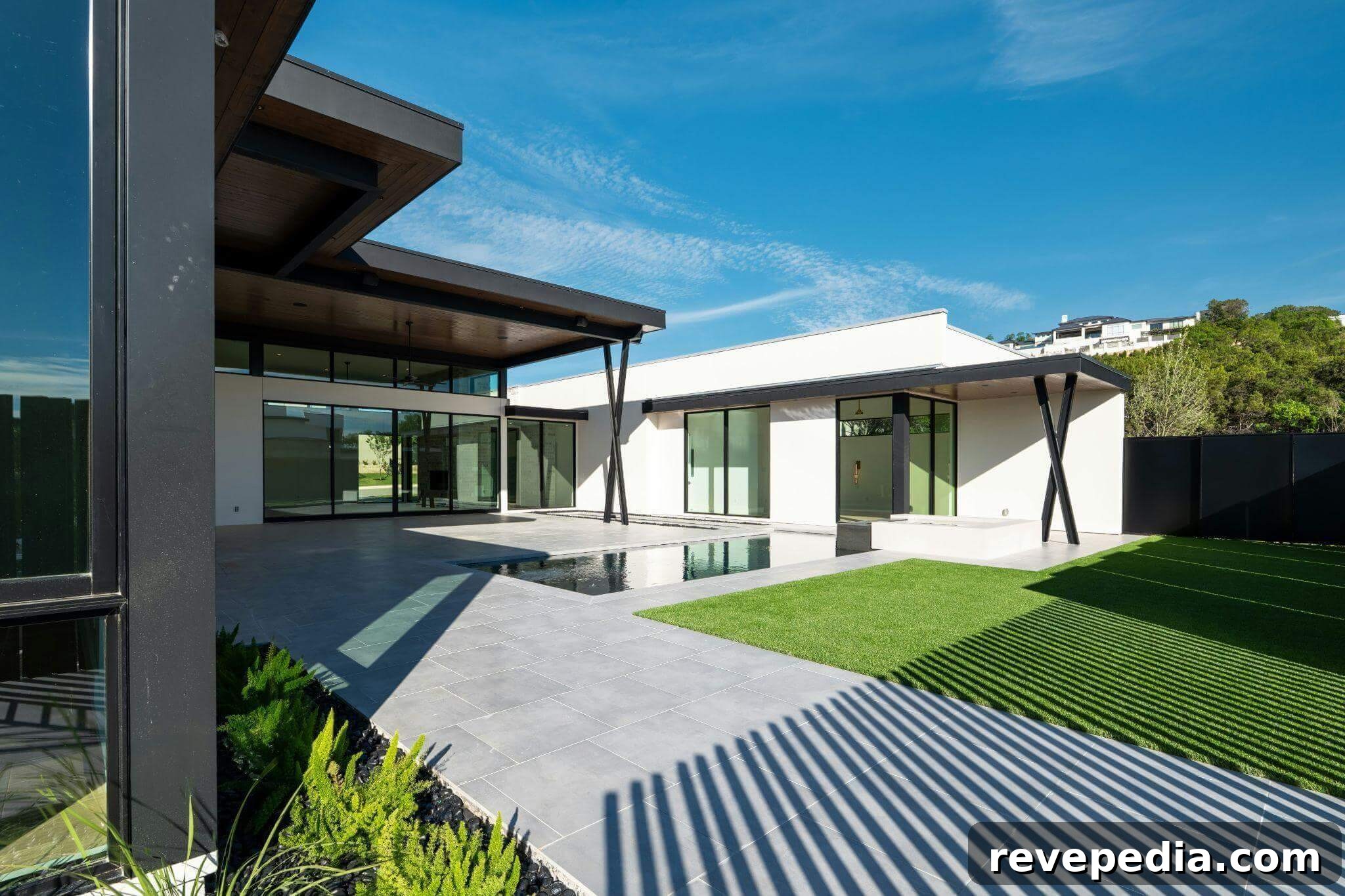 modern house with a pool in front of
